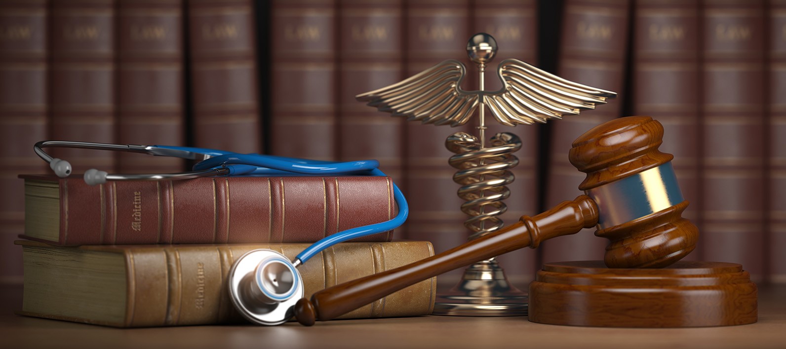 Gavel, stethoscope and caduceus sign on books background. Mediic