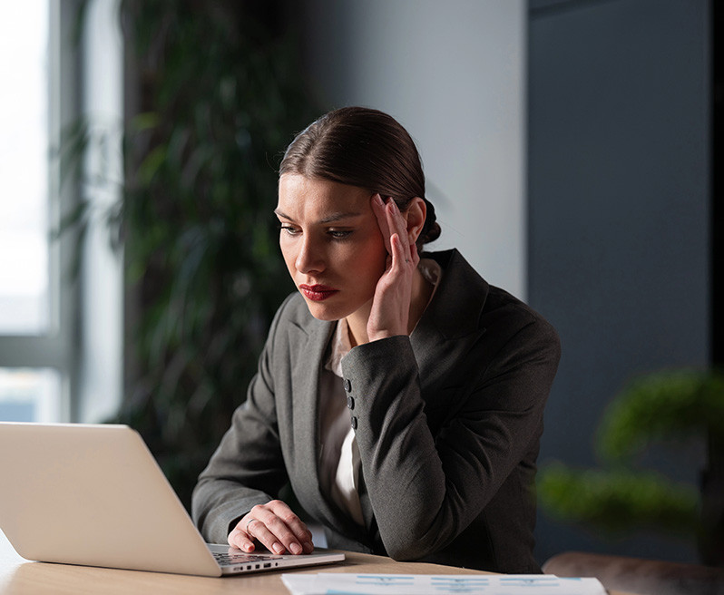Businesswoman, executive, or consultant in a suit working on a l